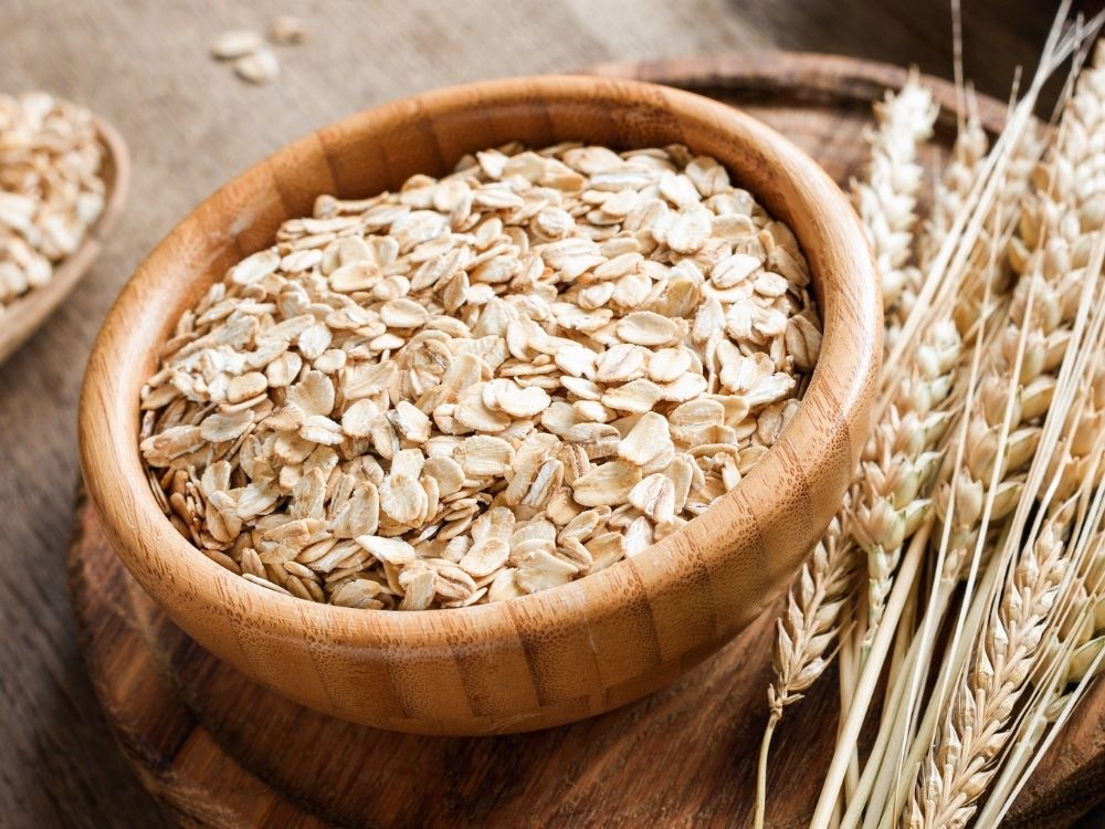 raw oats in a wooden bowl