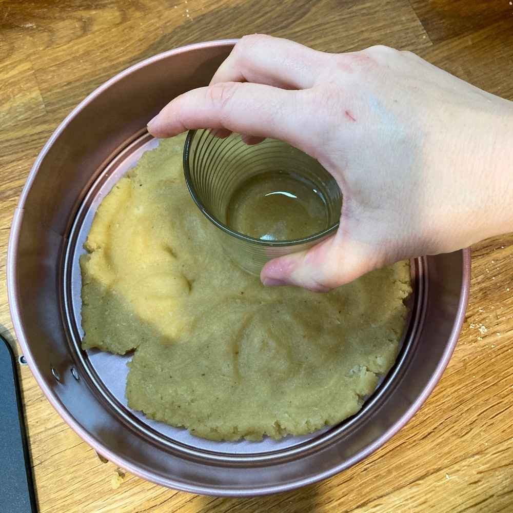pressing the crust into the pan