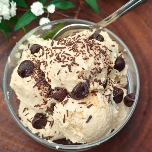 Cottage cheese cookie dough in a glass serving cup topped with chocolate chips