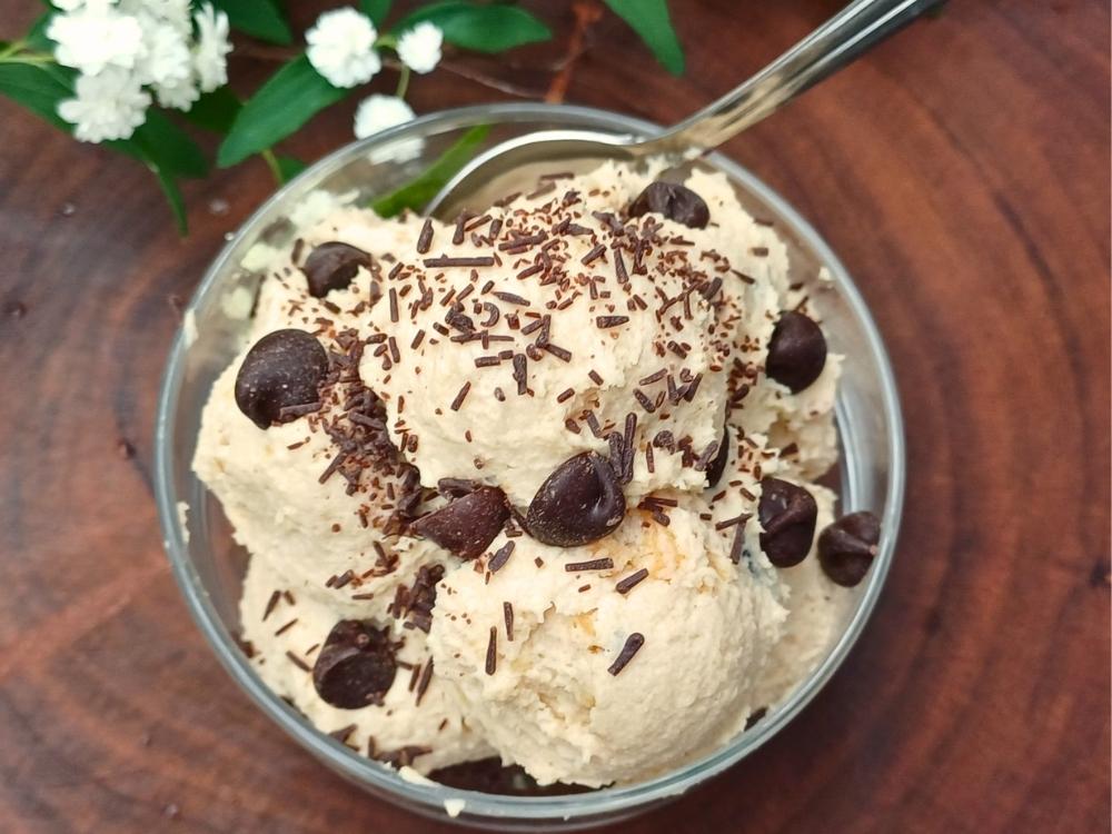 Cottage cheese cookie dough in a glass serving cup topped with chocolate chips