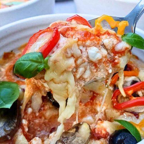 Cottage cheese pizza bowl close up with vegetables on top