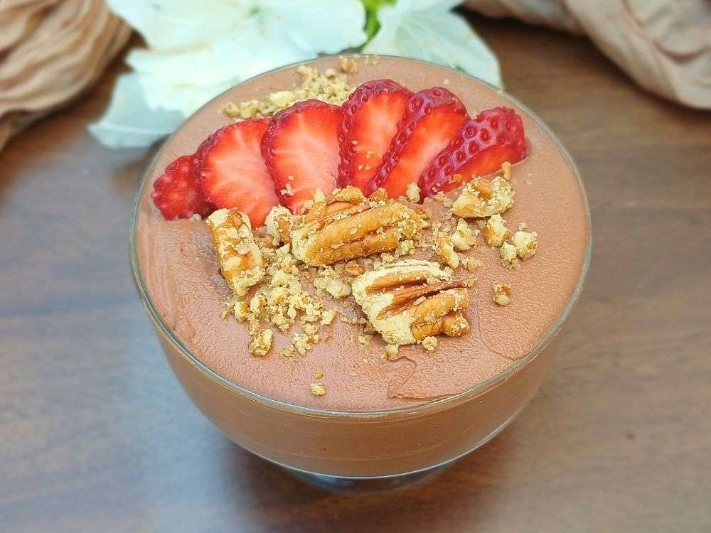 Cottage cheese mousse dessert on a brown wooden serving board.