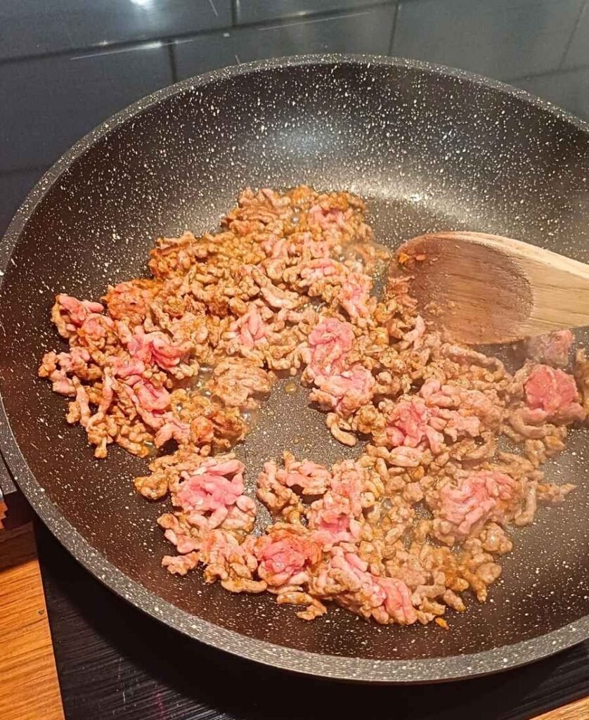 Cooking ground beef for queso on a hot pan