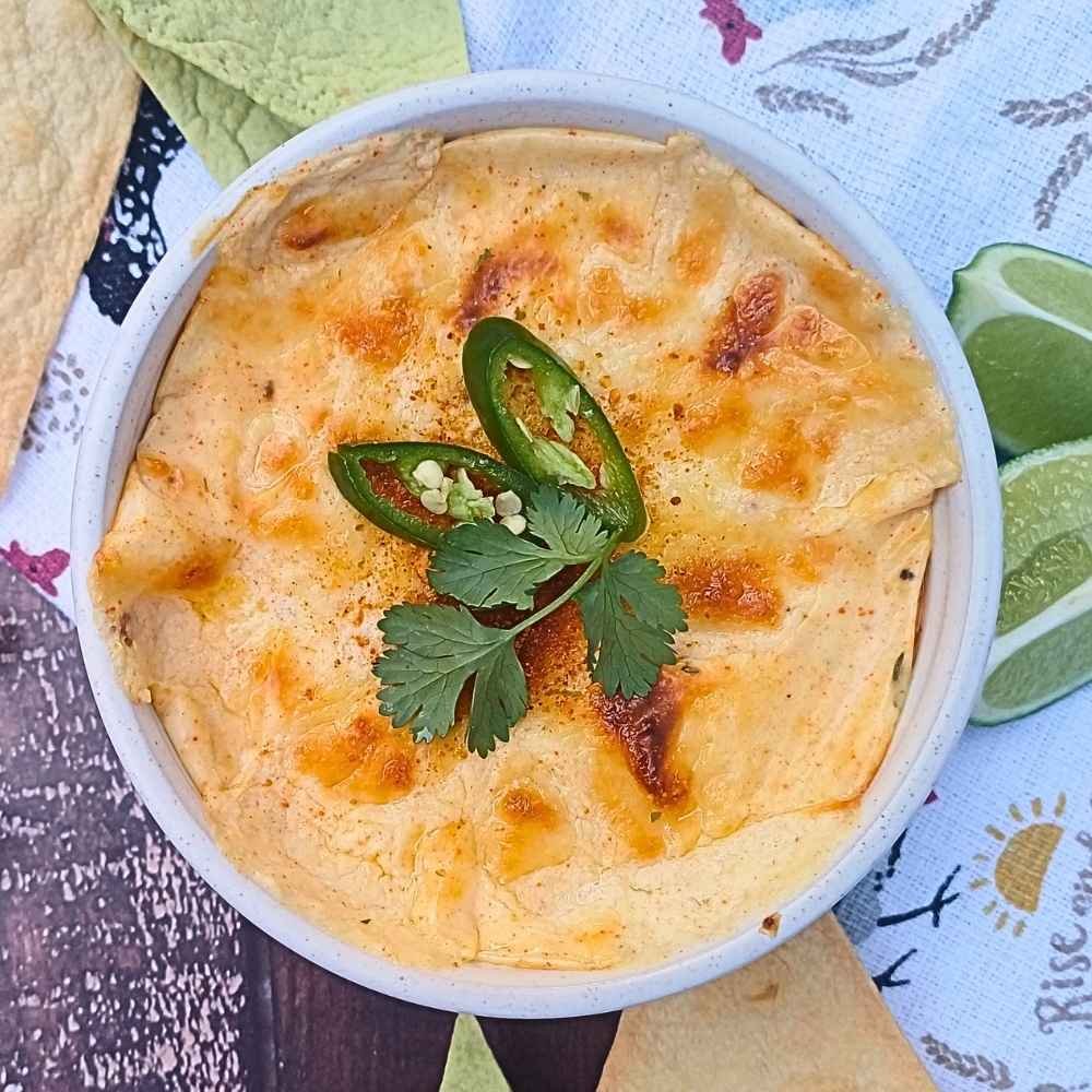 Cottage Cheese Queso topped with green chilis and ciantro
