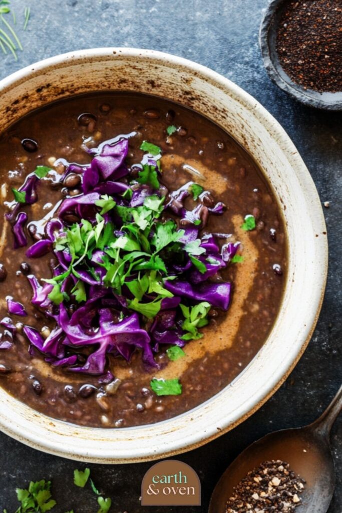 purple black bean soup top view in a rustic bowl
