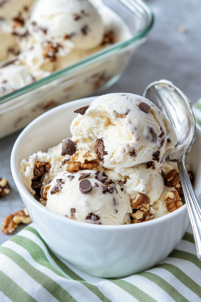 Ben and Jerry's Chunky Monkey Ninja Creami Protein Ice Cream version in a white bowl on a green stripy cloth.