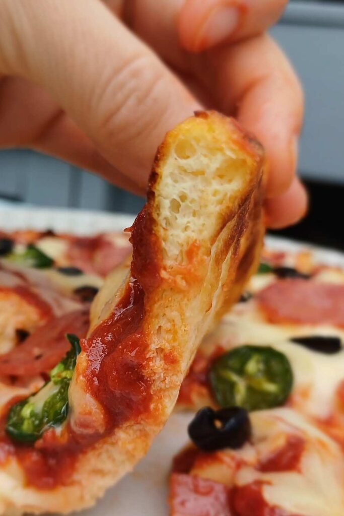 A slice of pizza shown on the side