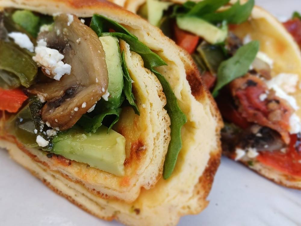 avocado and vegetables with fetta cheese wrapped in cottage cheese flatbread