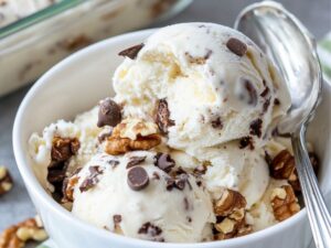 Chunky Monkey Ninja Creami Recipe Ice Cream in a white bowl with nuts and chocolate chips