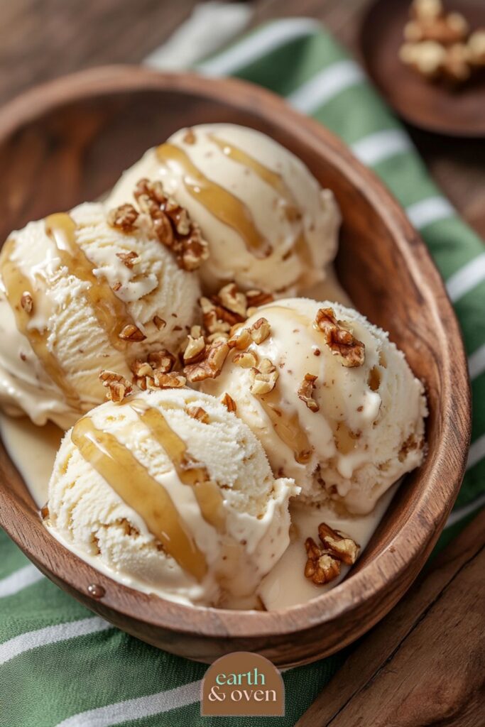 Maple wallnut four scoops of Ninja Creami Protein Ice Cream in a wooden bowl drizzled with maple syrup.