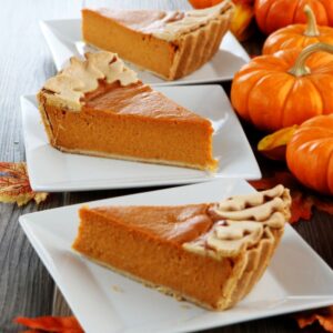 Pumpkin pie slices on white square plates
