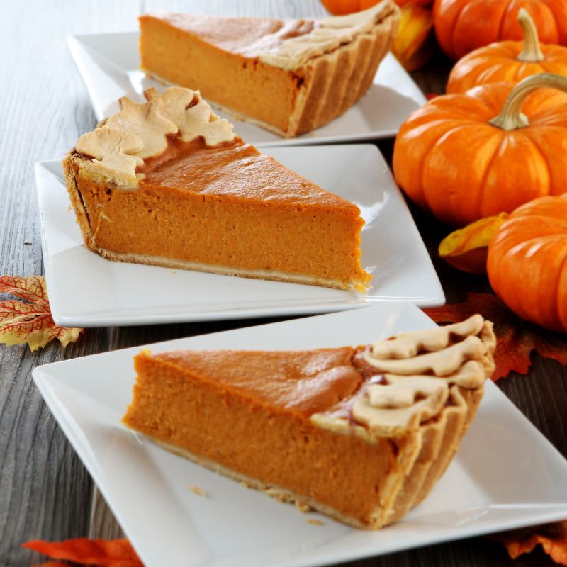 Pumpkin pie slices on white square plates