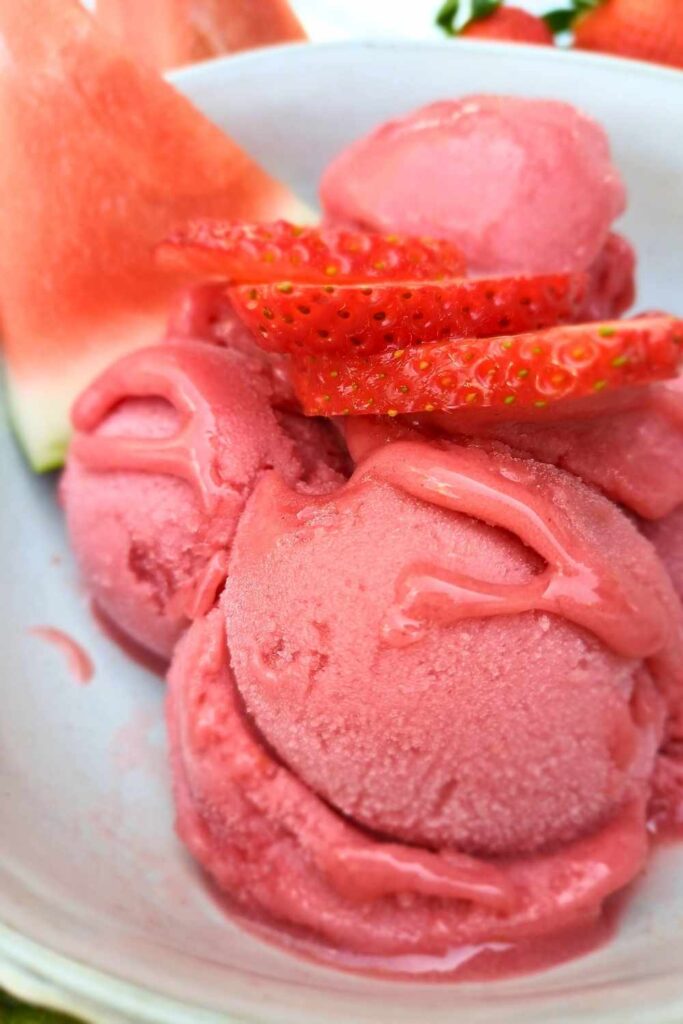 Scoops of home made strawberry and watermelon sorbet in a white bowl