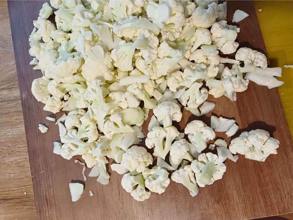 Chopped fresh cauliflower on a wooden board