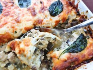 Close up of the inside of the keto chicken mushroom casserole spooned out of a baking dish.