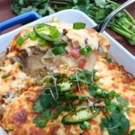 Close up of a keto taco casserole with fresh herbs on top