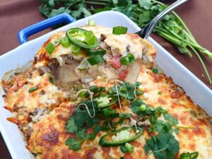 Close up of a keto taco casserole with fresh herbs on top