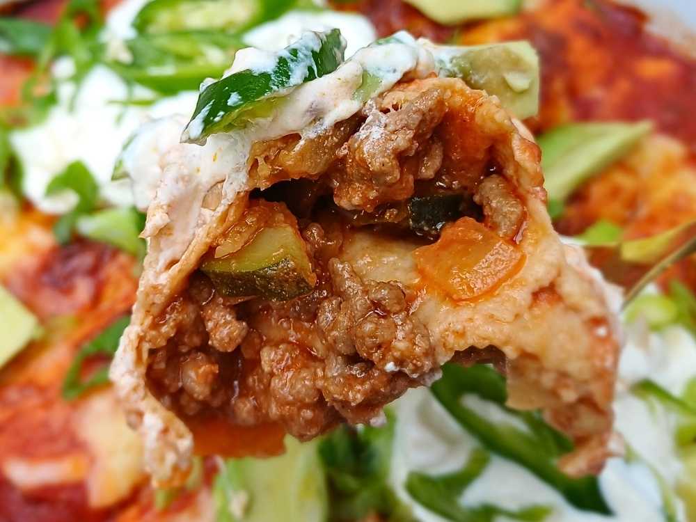 Close up view of a cut piece of beef enchilada