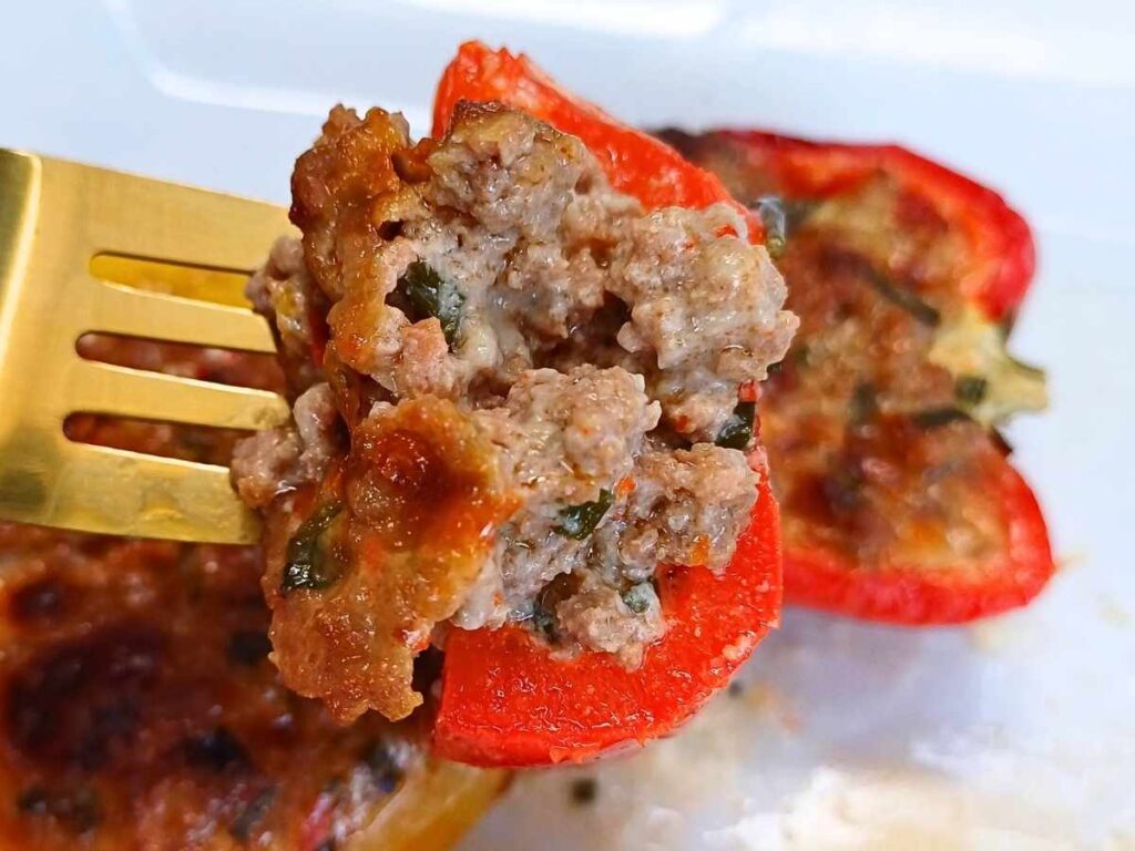 stuffed peppers with ground turkey baked on a gold fork