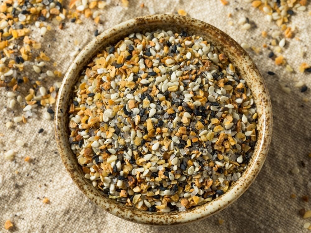 everything seasoning mix in a brown wooden bowl ona brown cloth