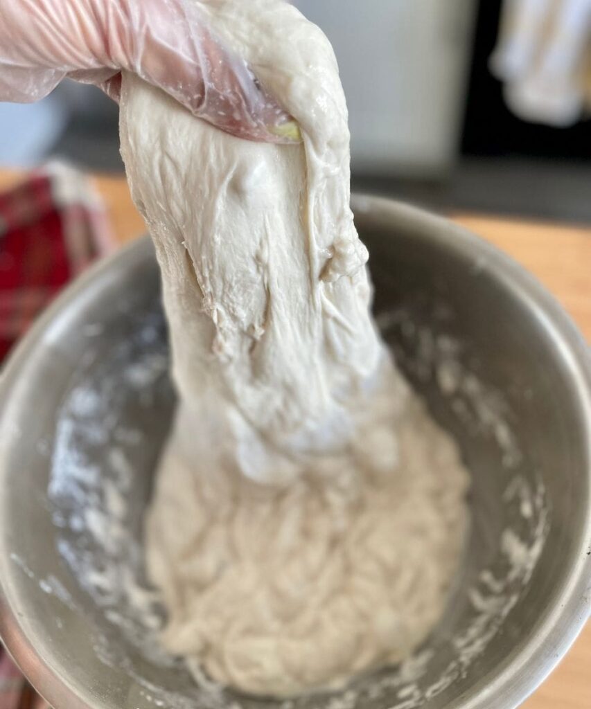 Making the dough with hands for sourdough bagels