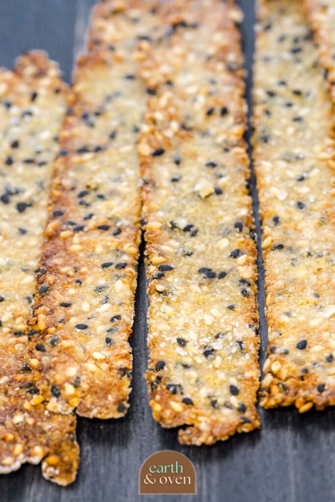 Sourdough discard crackers home made and cut in long strips with various seeds baked into them close up