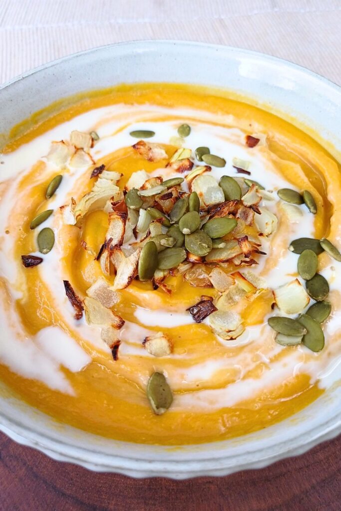 Butternut squash soup topped with caramelized onions and pumpkin seeds.