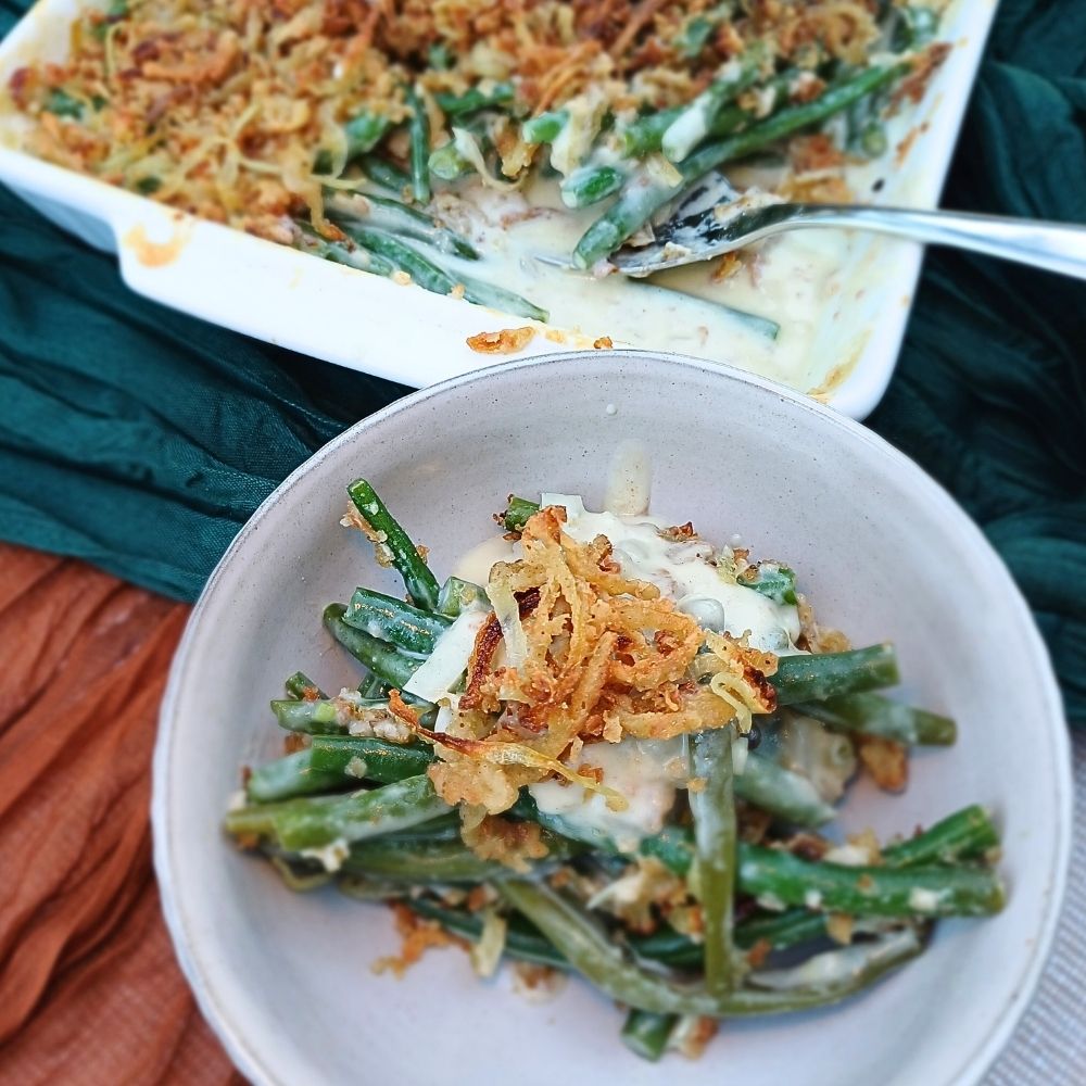Top down view of a green brean casserole in a bowl with crispy onions on top.