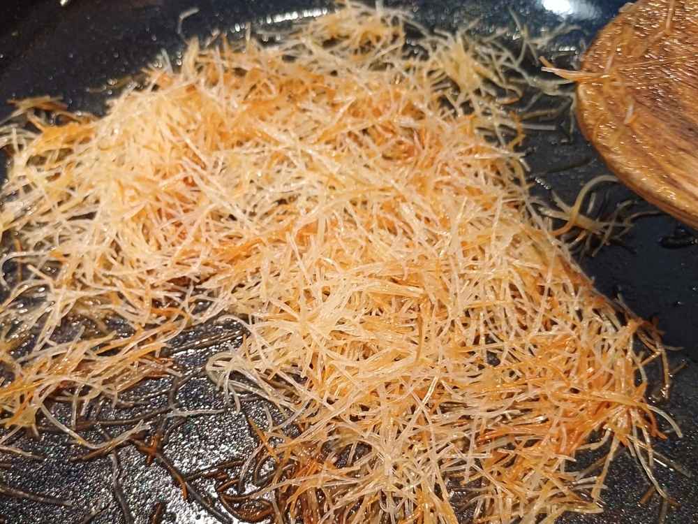 Toasting kataifi with butter on a saute pan