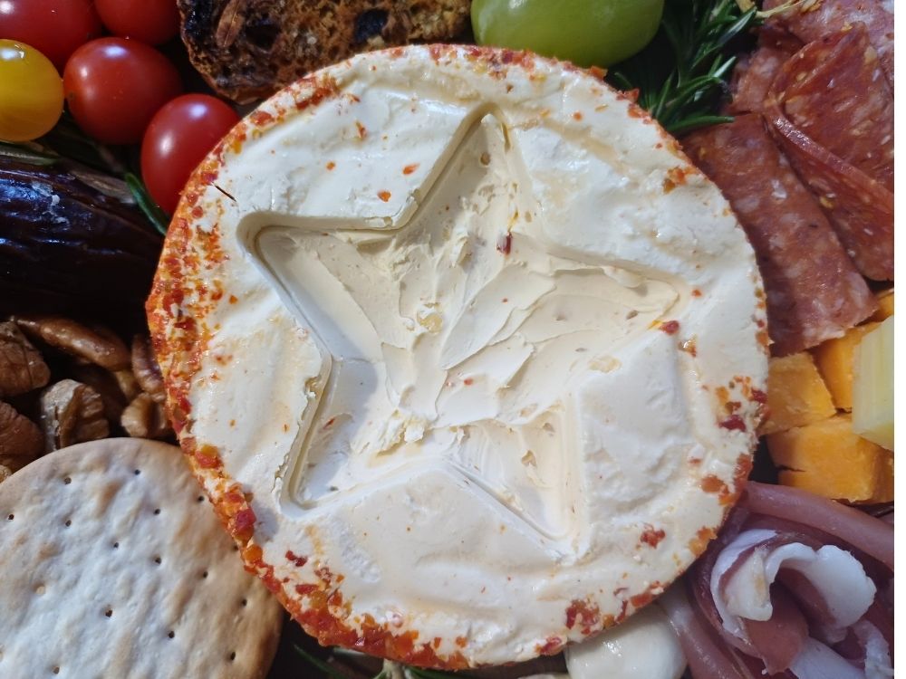A star shape carved out of a cheese wheel