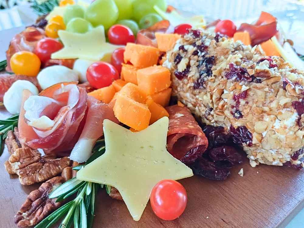 A close up of charcuterie board items like cheese and cured meats