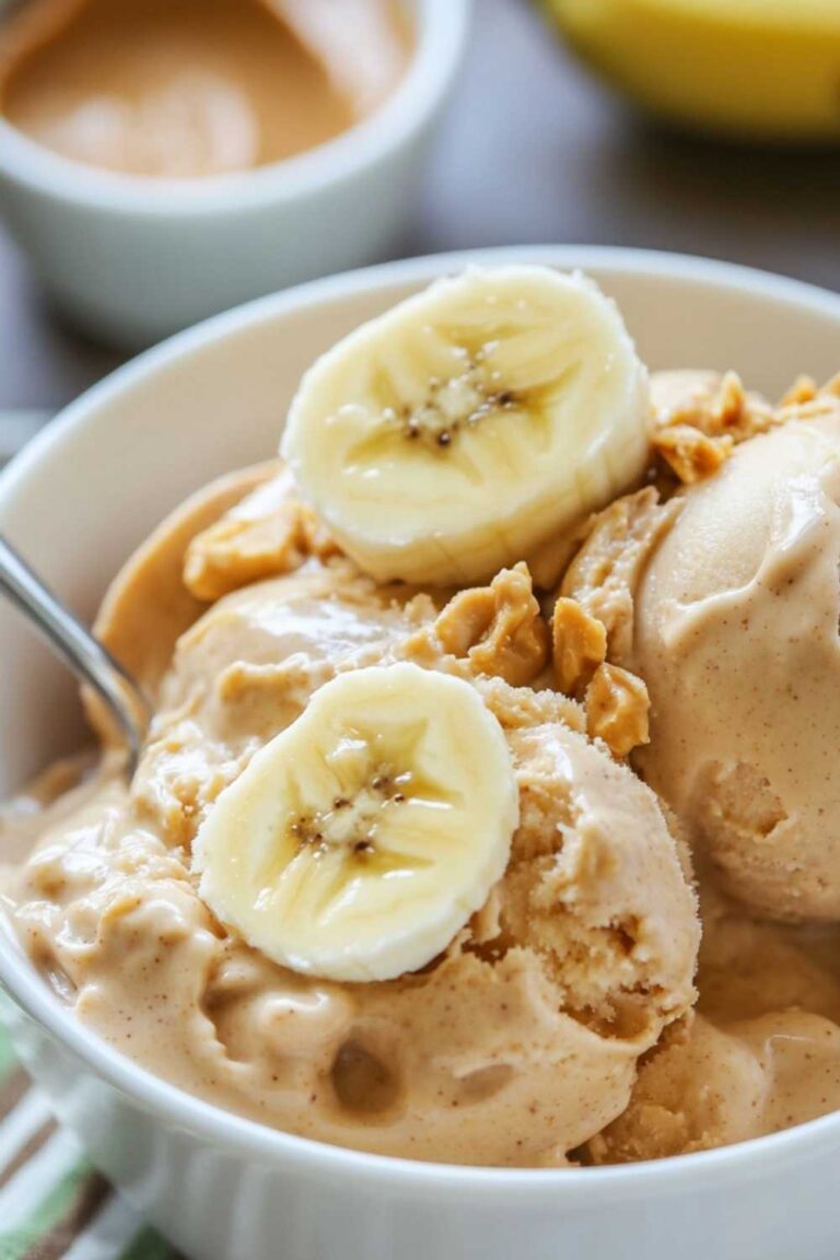 Scoops of homemade peanut banana and peanut butter Ninja Creami Ice cream in a white bowl