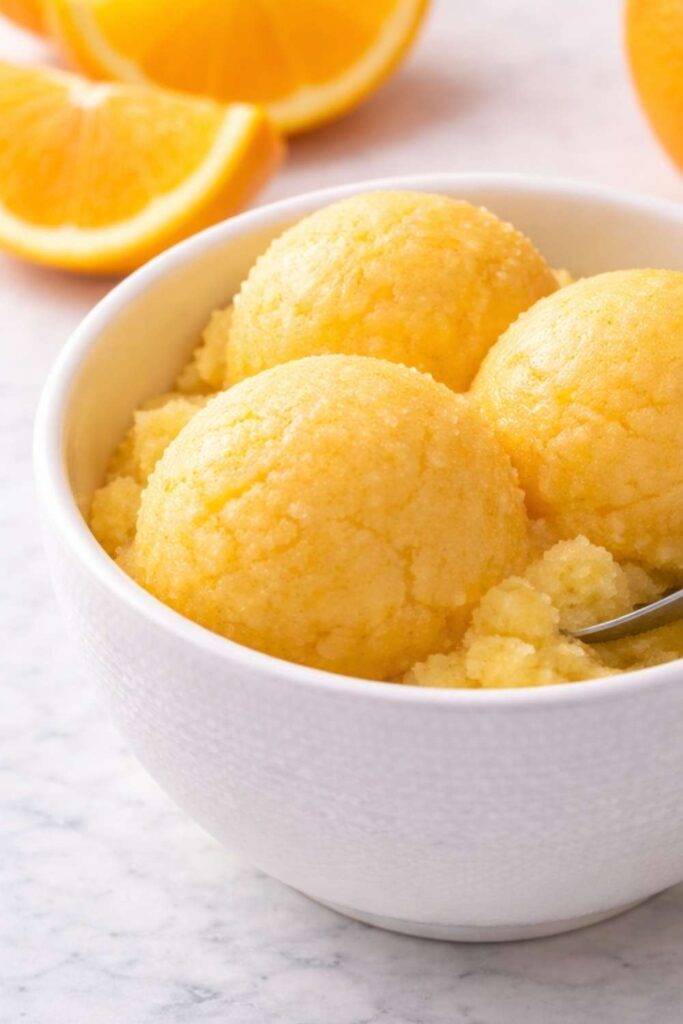 A white bowl of Ninja Creami orange sorbet