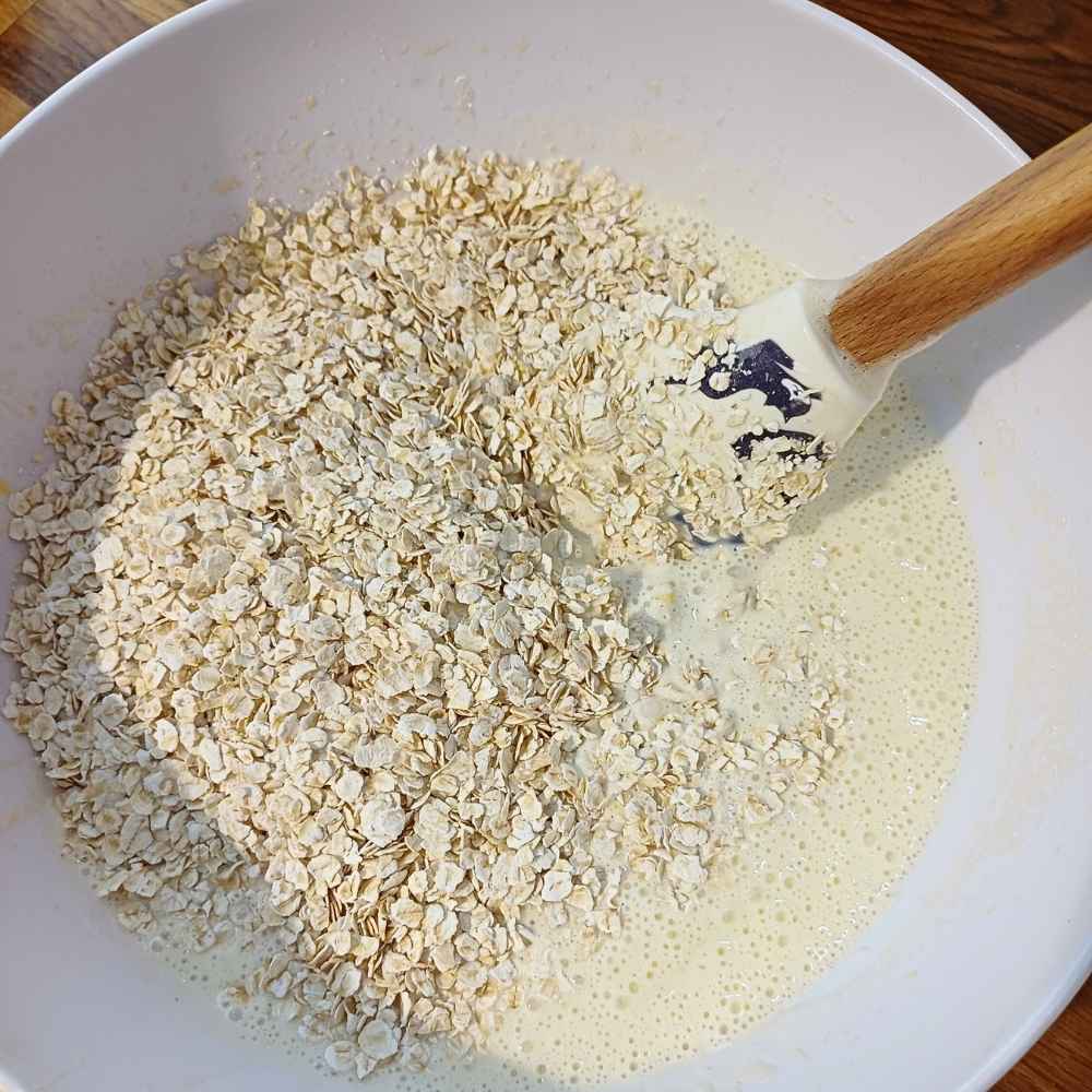 Oats being added to a cottage cheese egg mix