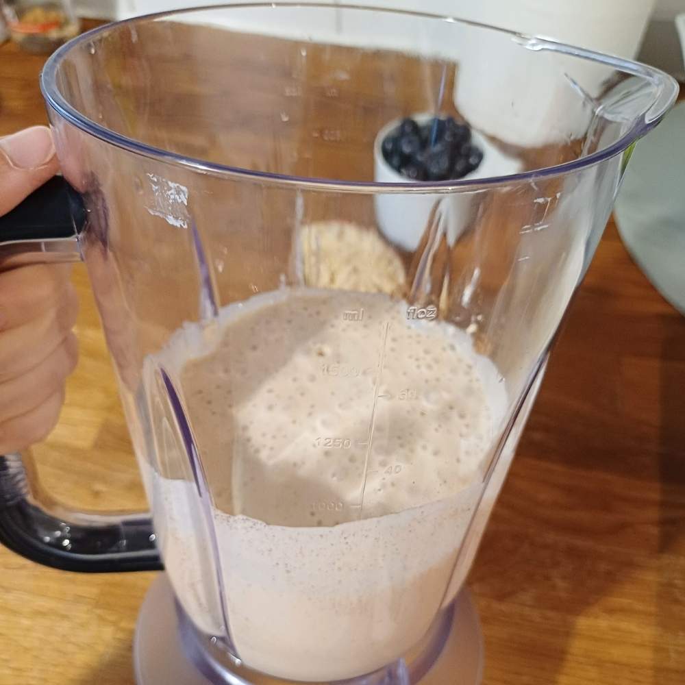 Blender with cottage cheese and eggs inside blended
