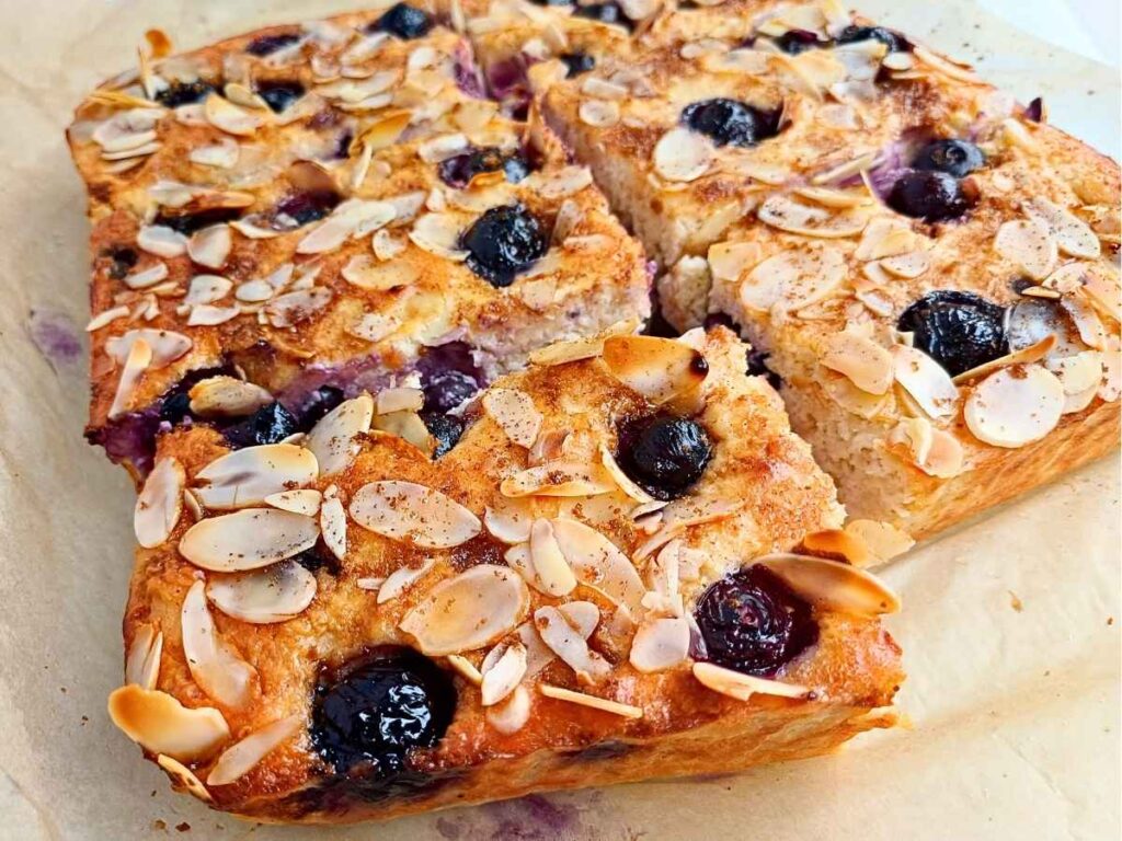Sliced blueberry cottage cheese breakfast bake on parchment paper