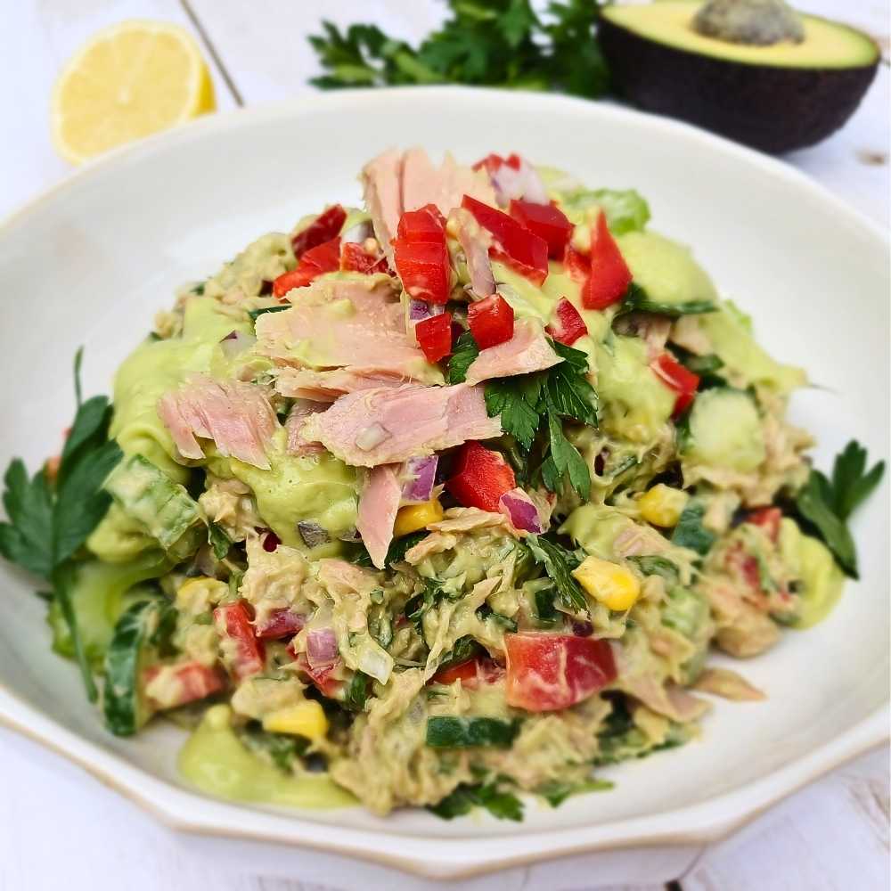 A bowl of healthy tuna salad with avocado dressing
