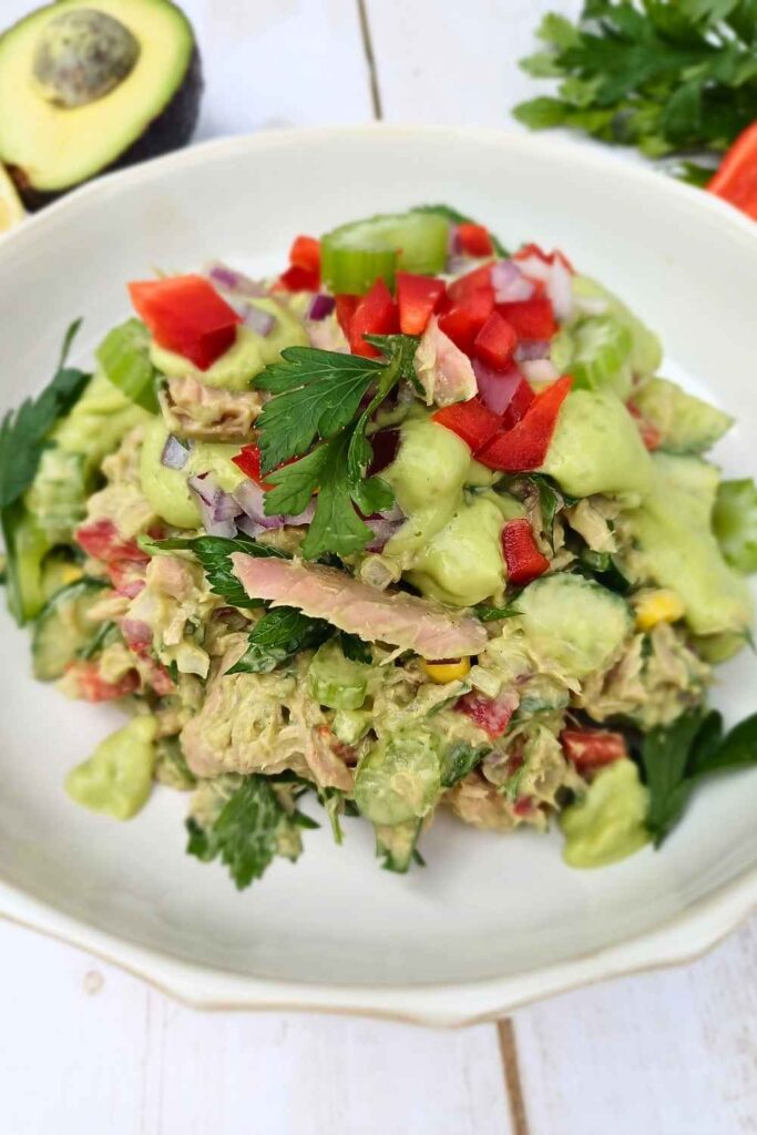 Healthy tuna salad with avocado dressing in a white bowl