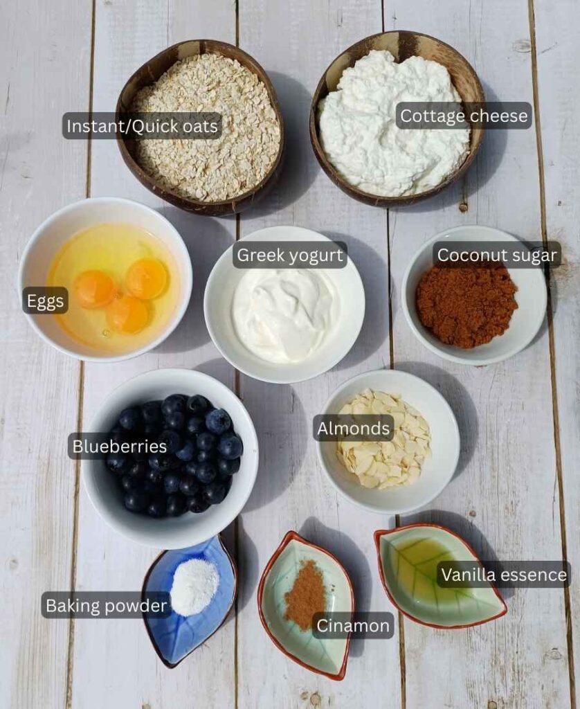 Ingredients with labesl for a cottage cheese breakfast bake with blueberries and oats