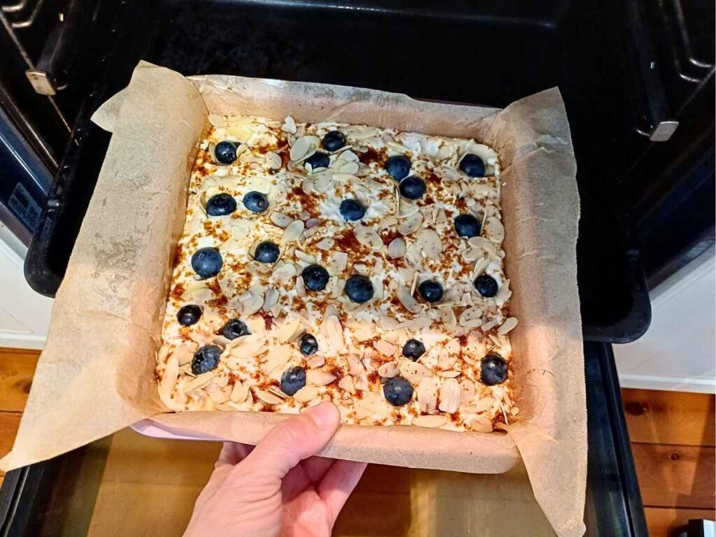 blueberry cottage cheese breakfast bake being put into the oven