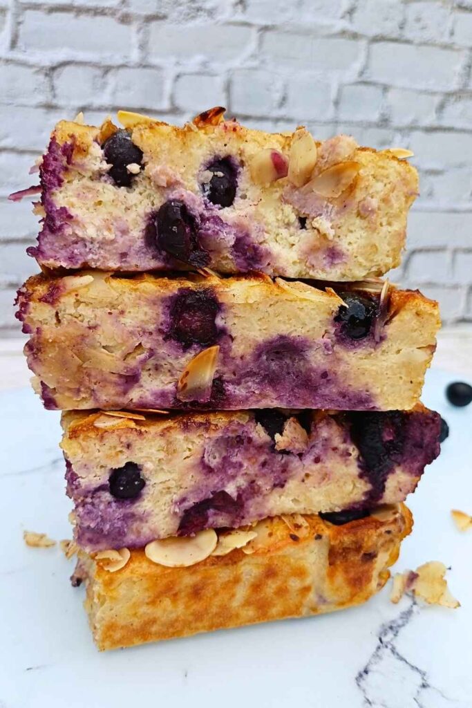 Stack of four slices of blueberry cottage cheese breakfast bake on top of each other