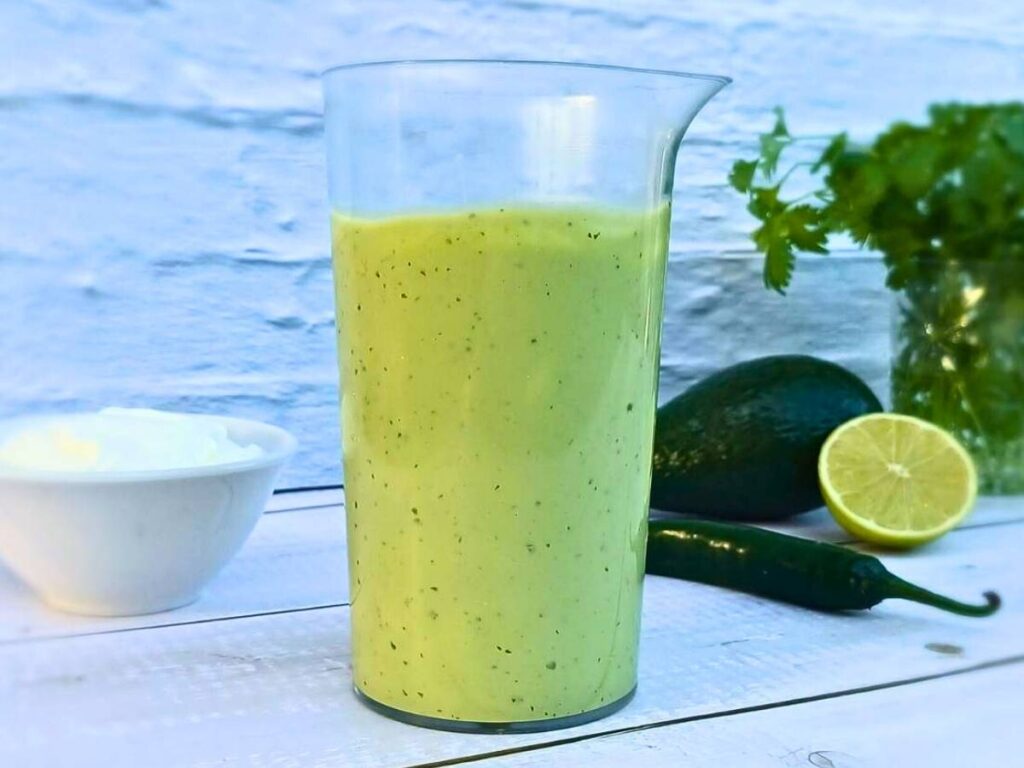 A tall jar of avocado lime ranch dressing made at home
