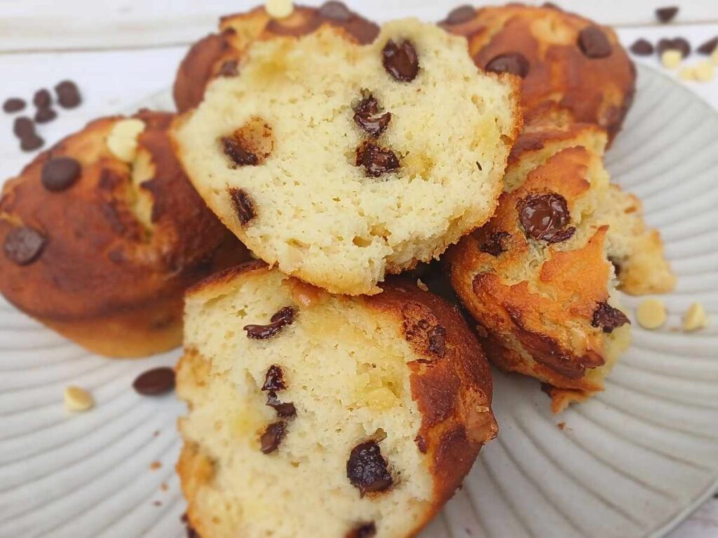 Choclate chip muffins broken on a plate showing inside, muffing are made with almond flour