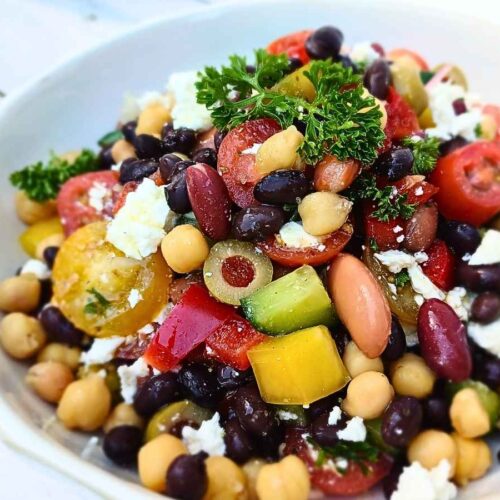 A bowl of healthy dense bean salad with vegetables