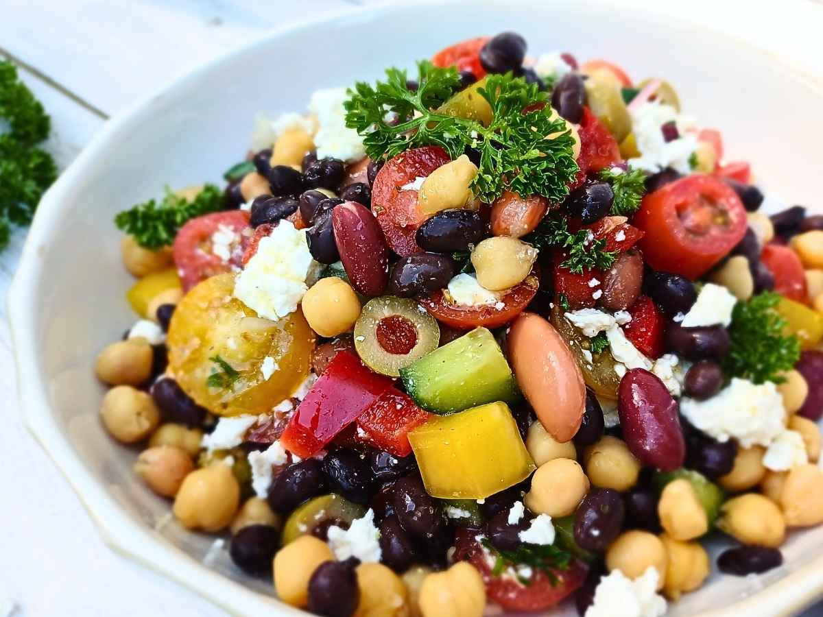 A bowl of healthy dense bean salad with vegetables