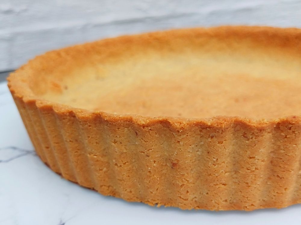 Almond flour pie crust showing golden fluited sides