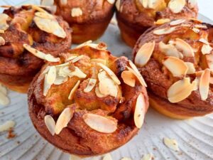 almond flour pumpkin muffins with sliced almonds on a plate