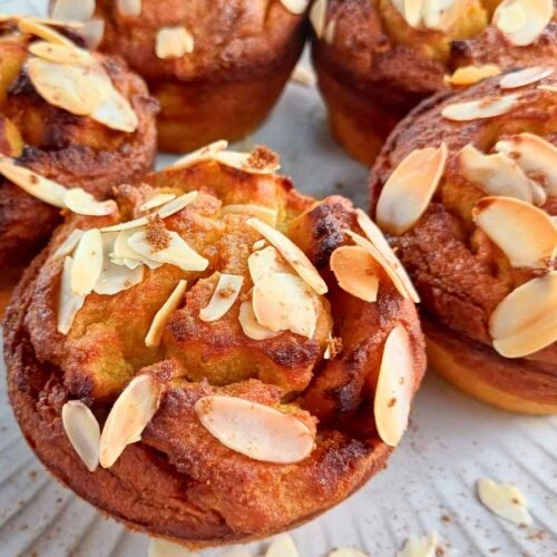 almond flour pumpkin muffins with sliced almonds on a plate