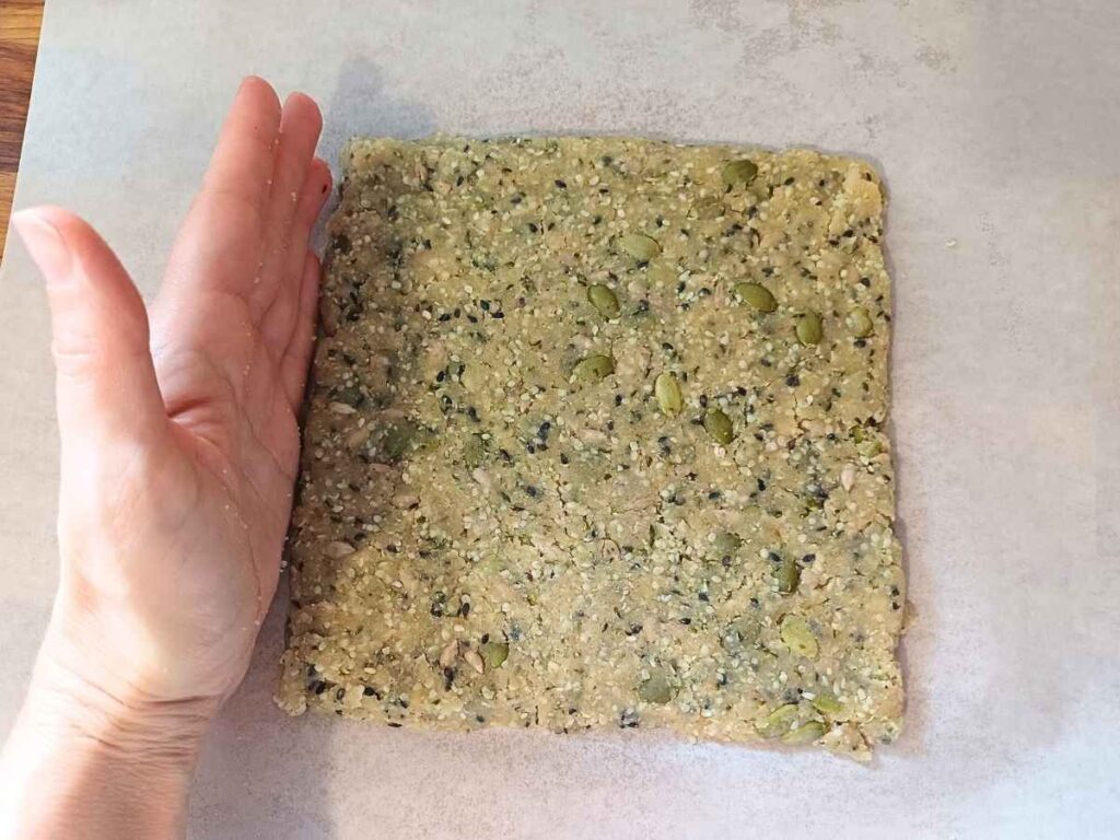 Square almond flour dough on the parchment paper