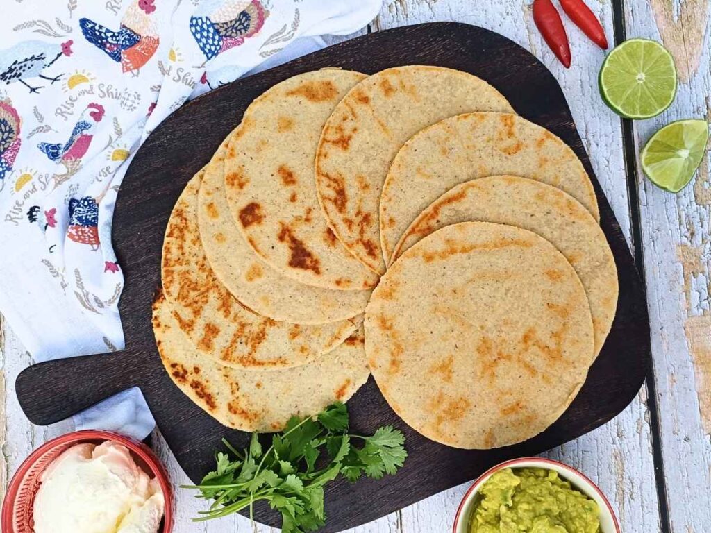Almond flour tortillas laid out on a woode board